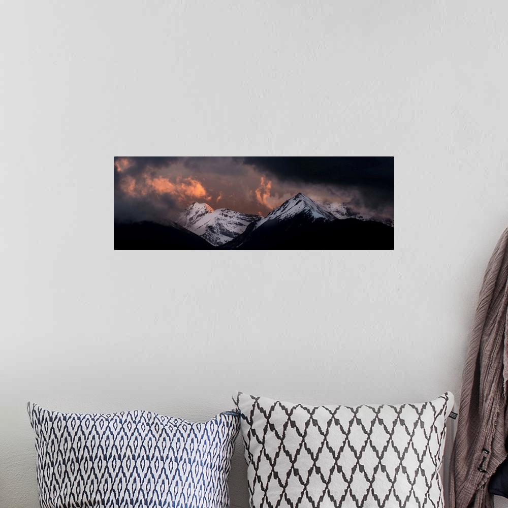 A bohemian room featuring Landscape photograph of snowy mountain peaks at sunset.
