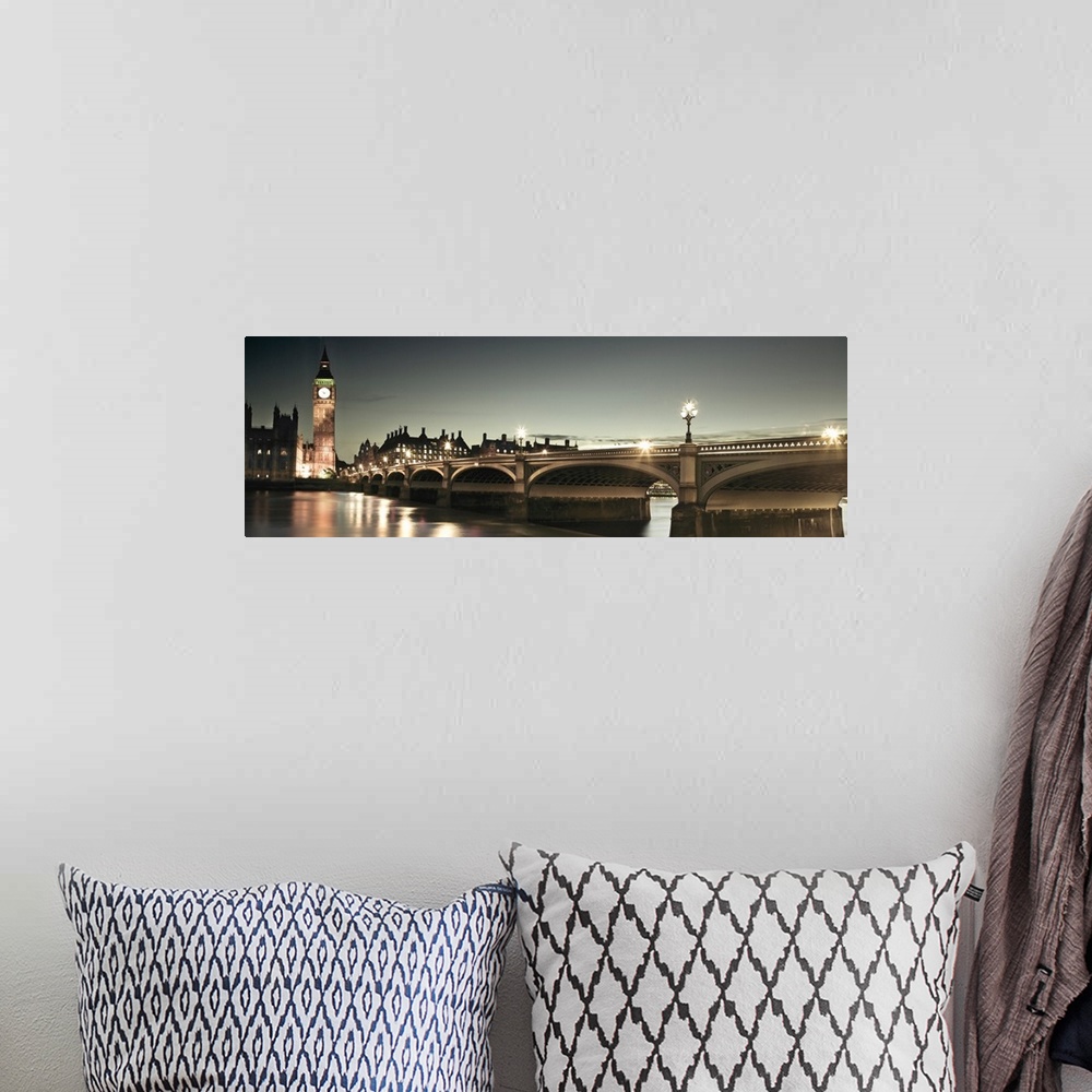 A bohemian room featuring A panoramic photograph of the Westminster Bridge next to Big Ben in London, England at night.