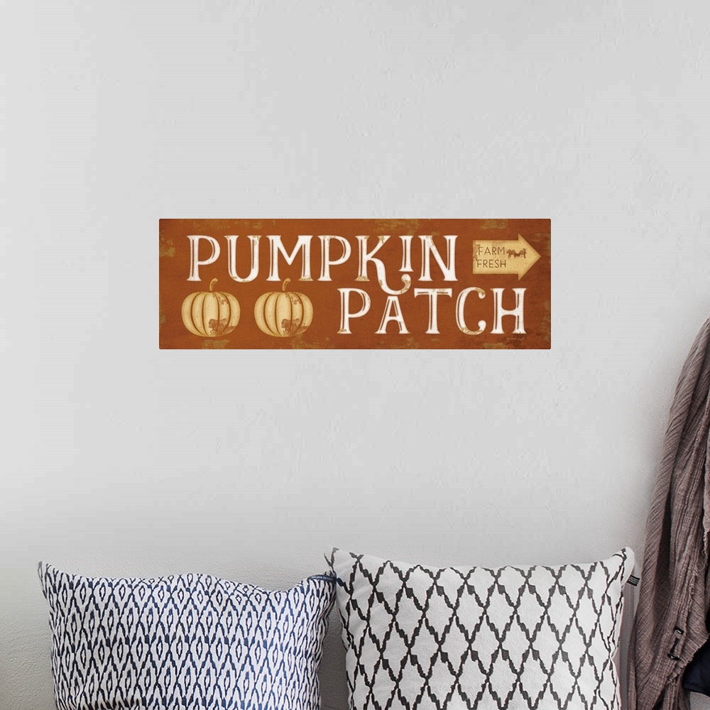 A bohemian room featuring Fall decor sign with the words, "Pumpkin Patch" and an arrow to mark direction.
