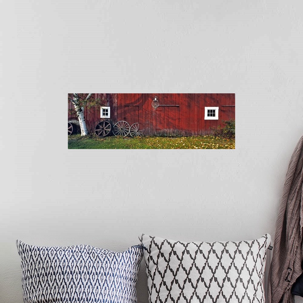 A bohemian room featuring USA, New Hampshire, Franconia Notch. Autumn color enhances the deep red siding of an old barn nea...