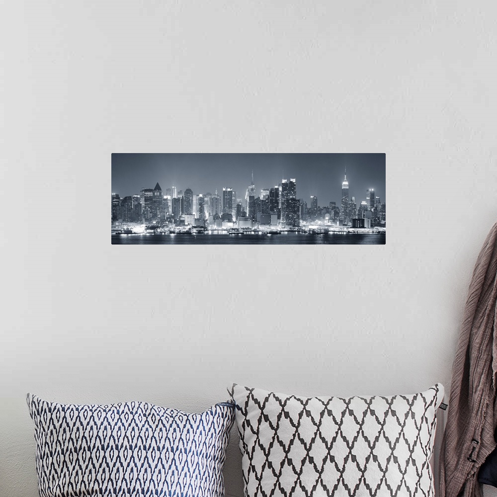 A bohemian room featuring Manhattan midtown skyline in black and white at night with skyscrapers lit over Hudson River with...