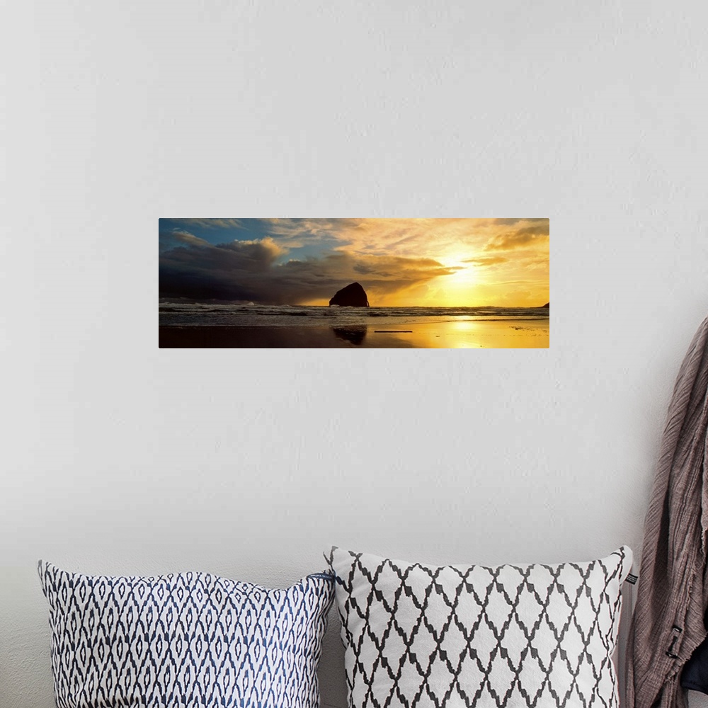A bohemian room featuring Sea stacks on the beach silhouetted at sunset, Pacific City, Oregon.