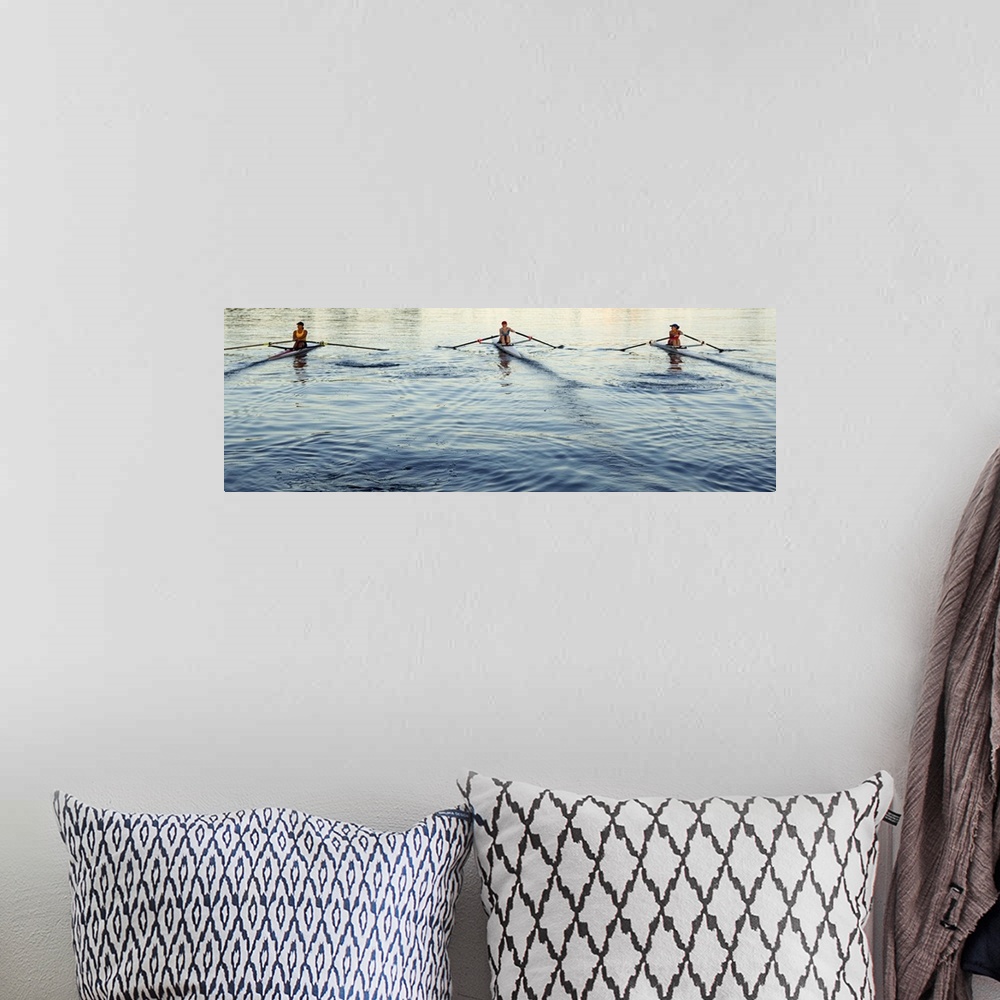 A bohemian room featuring People rowing sculling boats on river