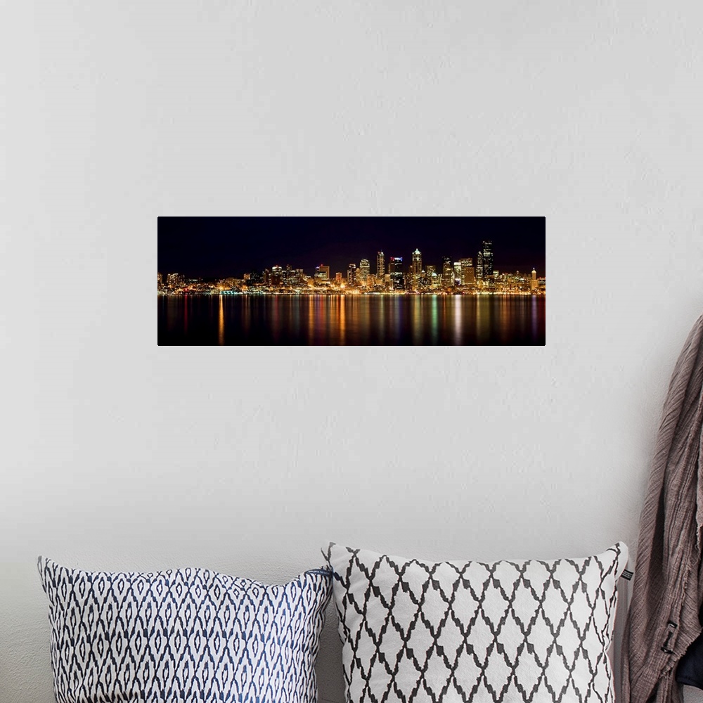 A bohemian room featuring Nighttime shot of downtown Seattle at night with lights of city reflected in water of Puget Sound.