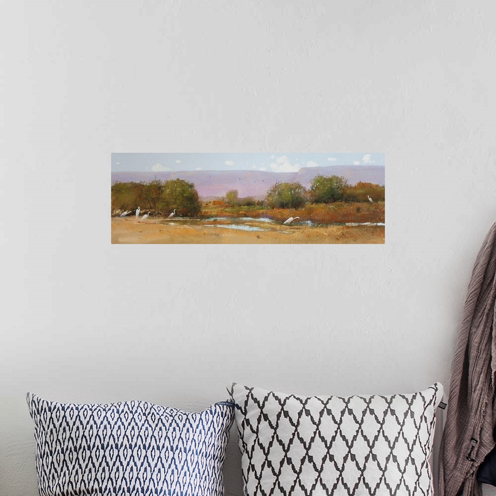 A bohemian room featuring A contemporary painting of a southwestern landscape under a purple sky.
