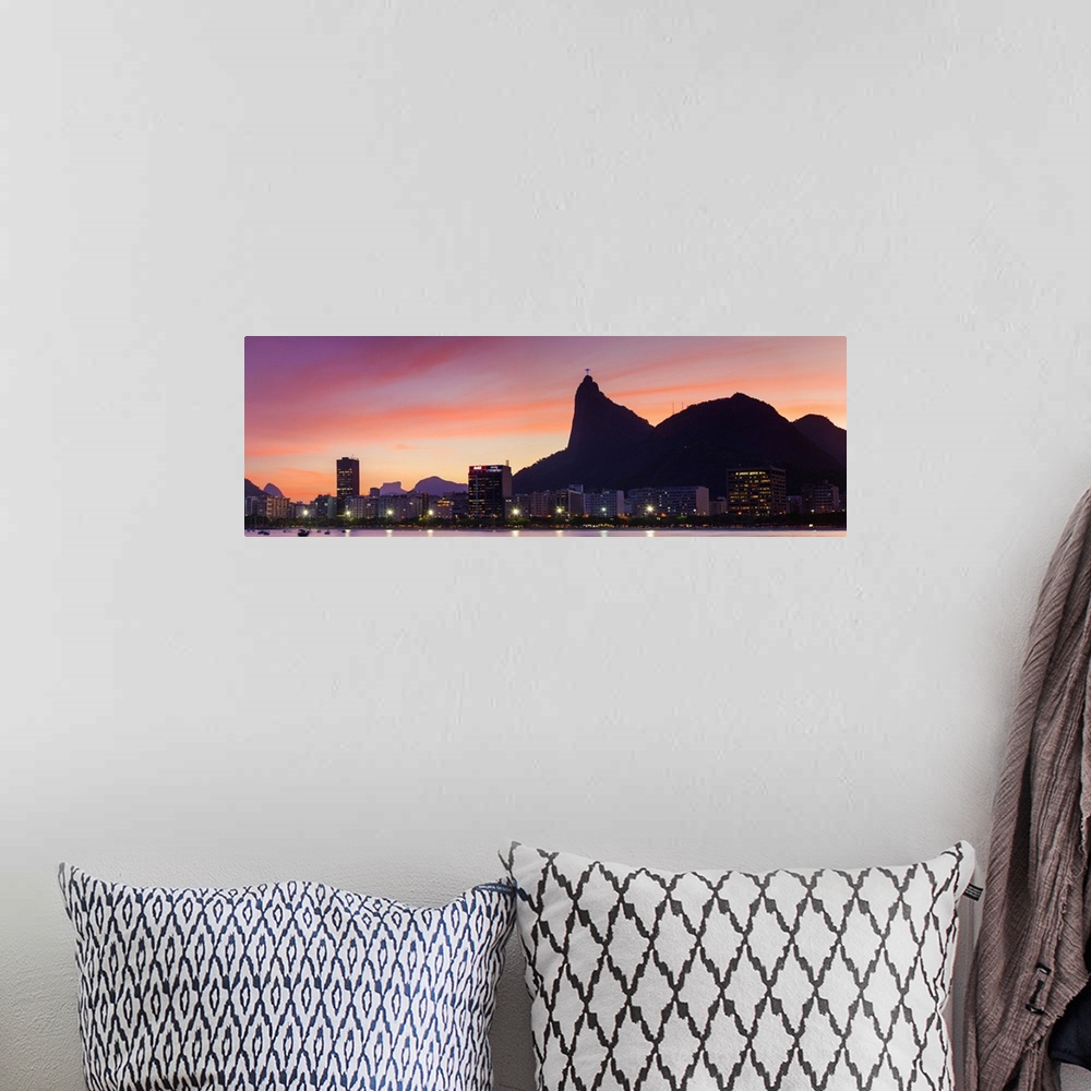 A bohemian room featuring Botafogo Bay and Christ the Redeemer statue at sunset, Rio de Janeiro, Brazil