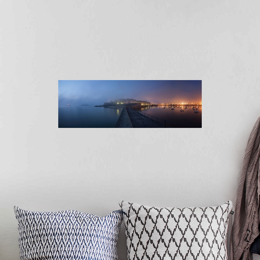 A bohemian room featuring Panoramic view of Saint Malo city in Brittany at night with fog coming from the sea, blue and pin...