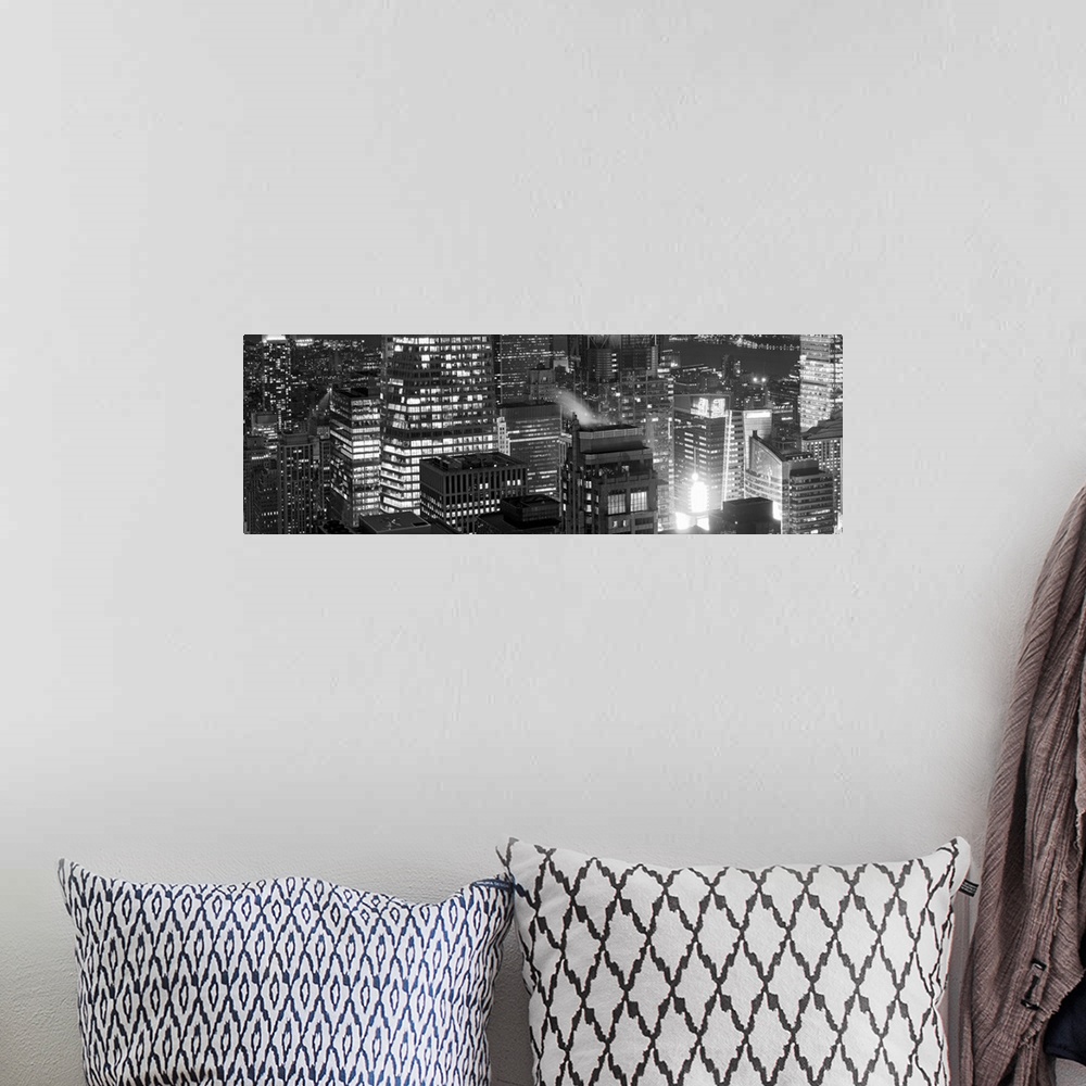 A bohemian room featuring Panoramic photograph of lit up buildings in the "Big Apple."