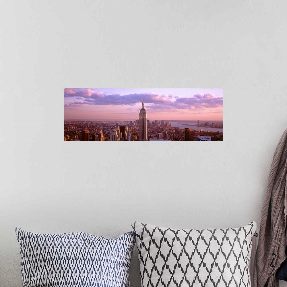 A bohemian room featuring Aerial panoramic picture of New York City and the top of the Empire State Building in the pink gl...