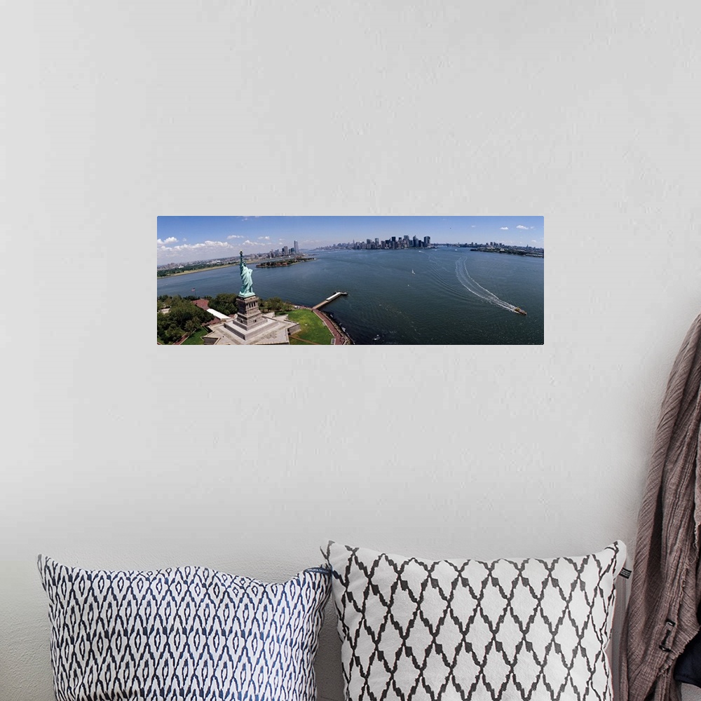 A bohemian room featuring Panoramic photograph of iconic "Big Apple" monument and waterfront under a cloudy sky.