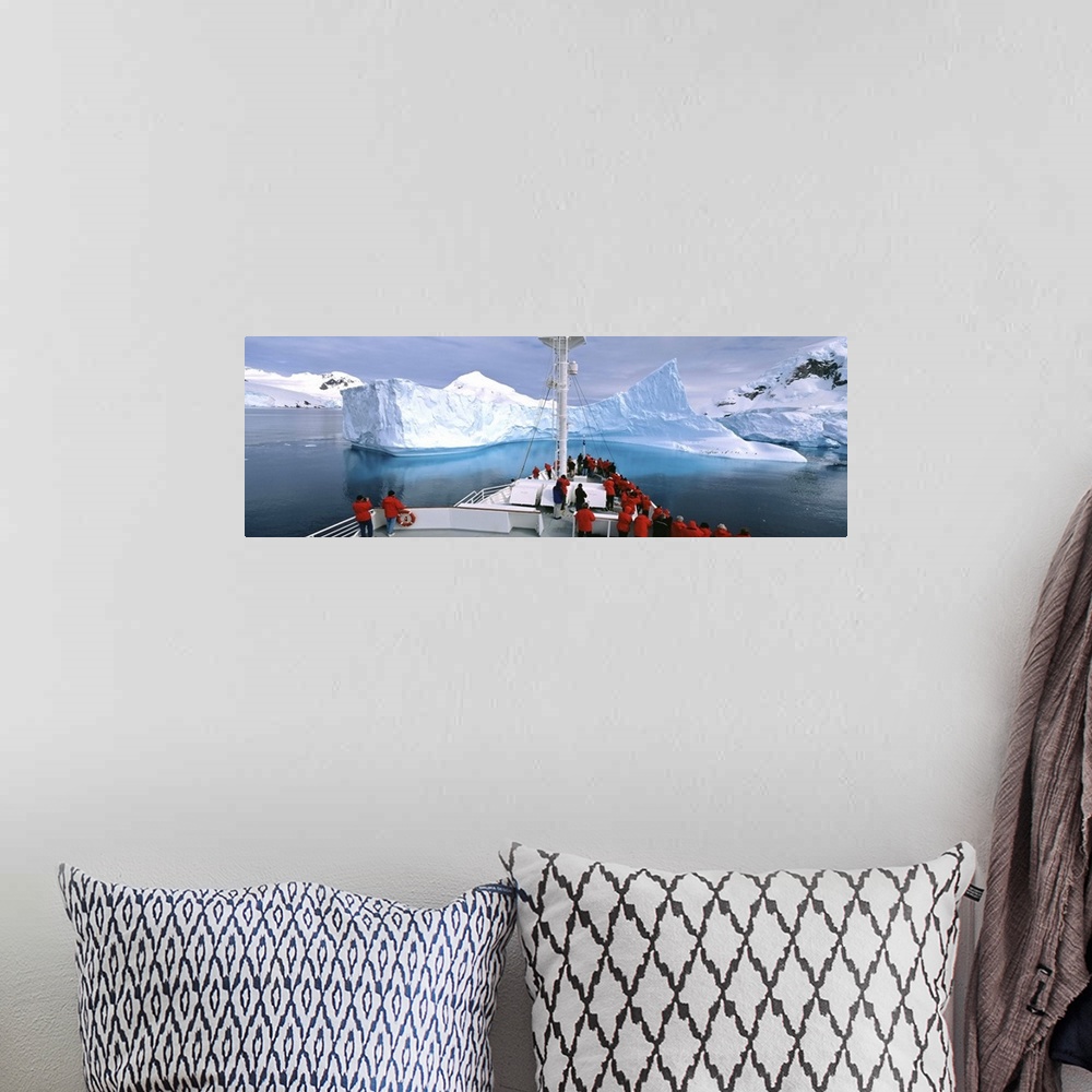 A bohemian room featuring Antarctica, Antarctic Peninsula, Tourists standing on a cruise ship watching at iceberg