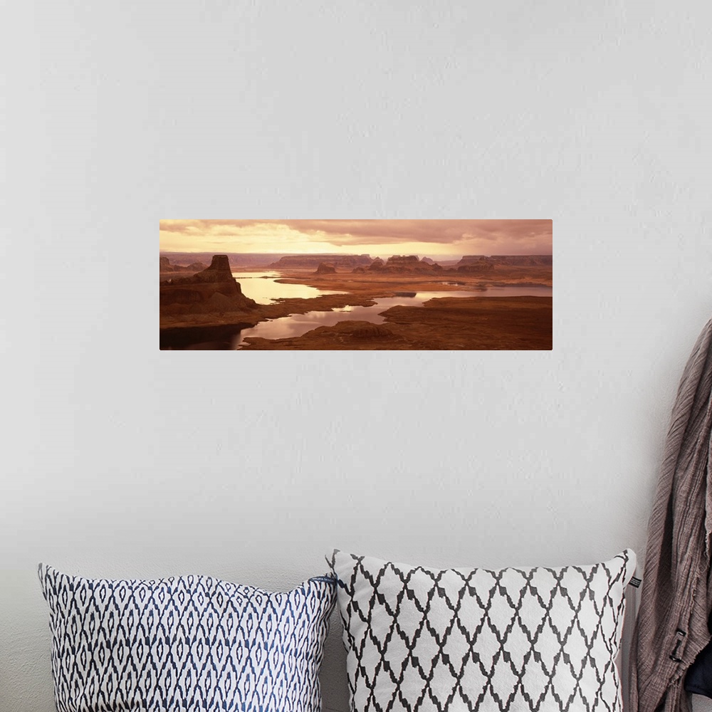 A bohemian room featuring Large panoramic photograph of the sun beginning to rise over Lake Powell and the red rock desert ...