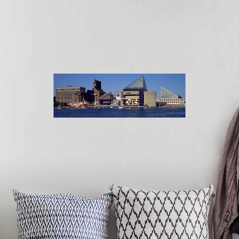 A bohemian room featuring Buildings in Baltimore are photographed in wide angle view from across the waterfront.