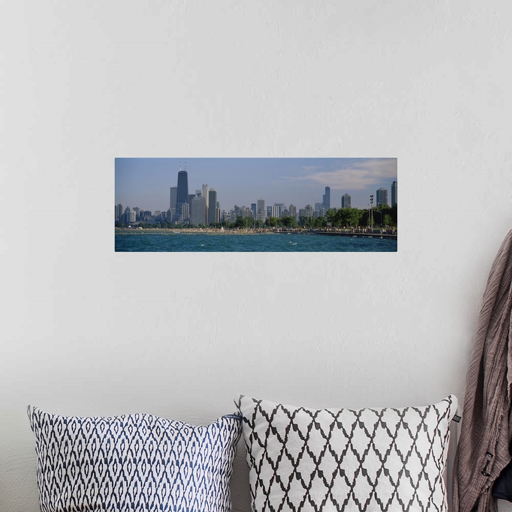 A bohemian room featuring Oversized, landscape photograph of the Chicago skyline, a crowded beach at the waters edge in the...