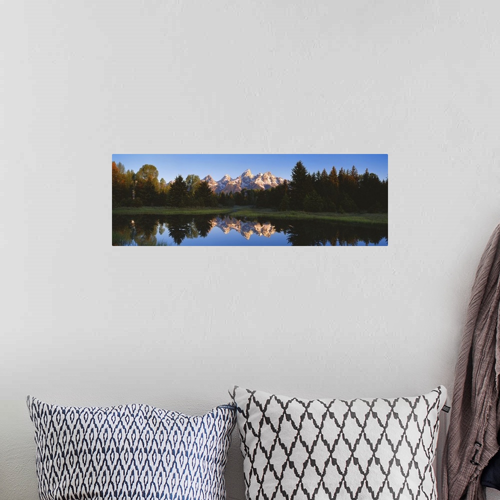 A bohemian room featuring Panoramic photo on canvas of a rugged mountain range in the distance of a tree line and a lake wi...