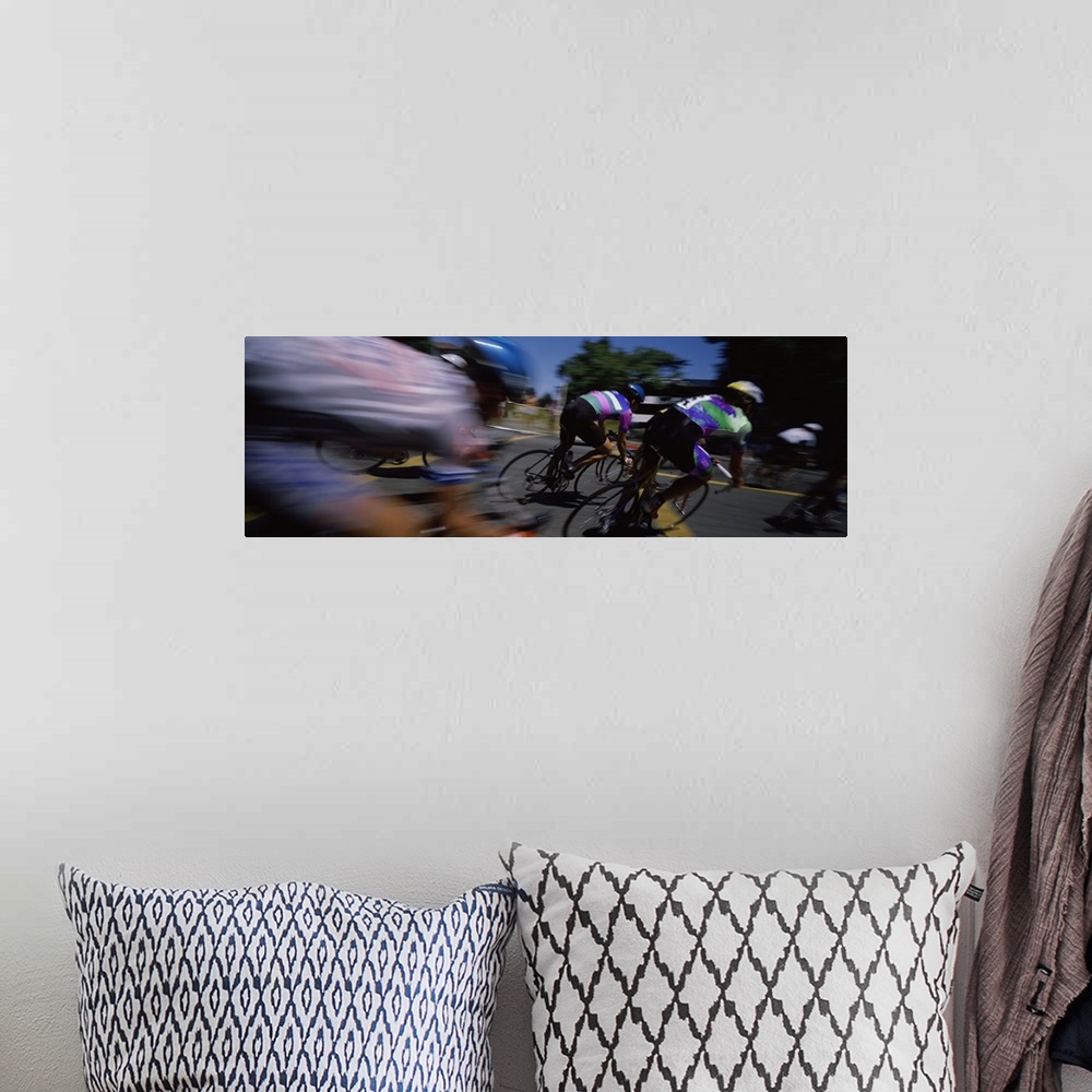 A bohemian room featuring Panoramic blur motion photograph of cyclists racing on the street.