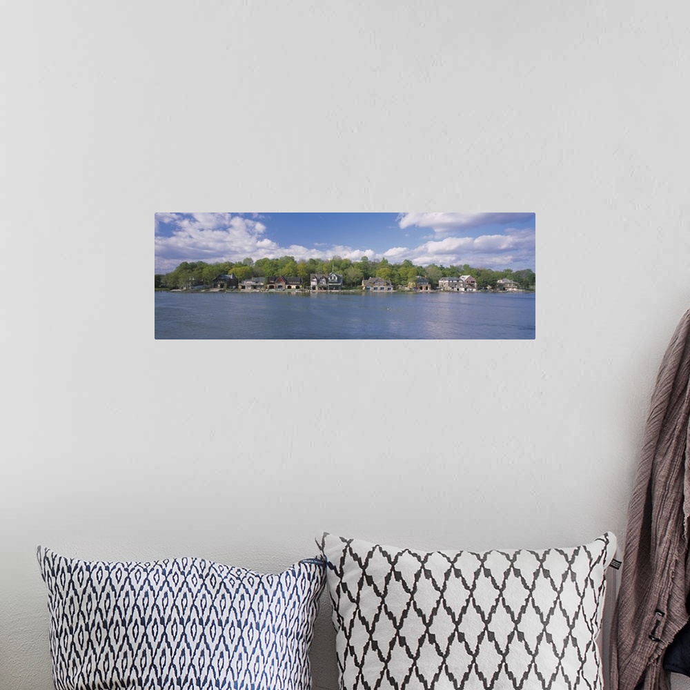 A bohemian room featuring Panoramic photo of boathouses lining a waterfront.