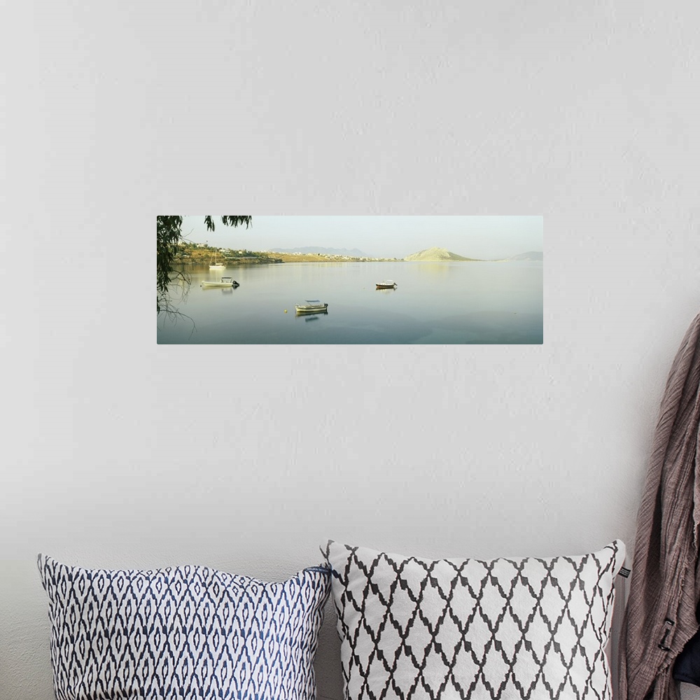 A bohemian room featuring Boats in the sea with a city in the background, Aegina, Saronic Gulf Islands, Attica, Greece