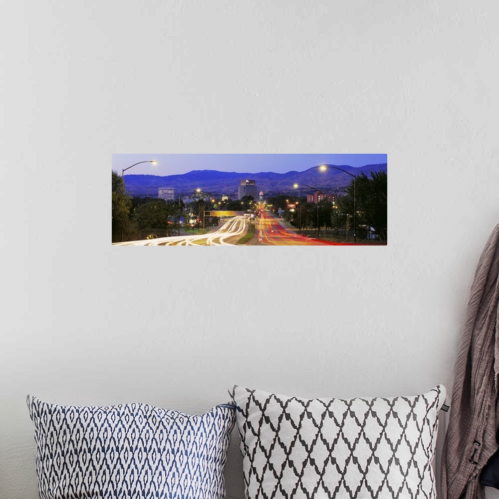 A bohemian room featuring Panoramic photograph taken of a major highway in Boise with the lights of the cars shown as strea...