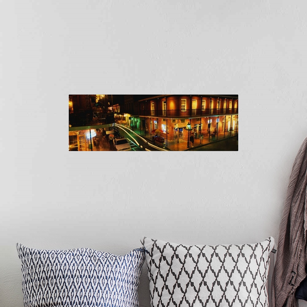 A bohemian room featuring Panoramic photograph displays a nighttime view of the busy streets within the French Quarter loca...