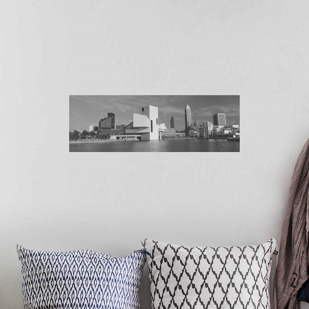 A bohemian room featuring A black and white panoramic photograph taken of buildings in Cleveland sitting on water with the ...