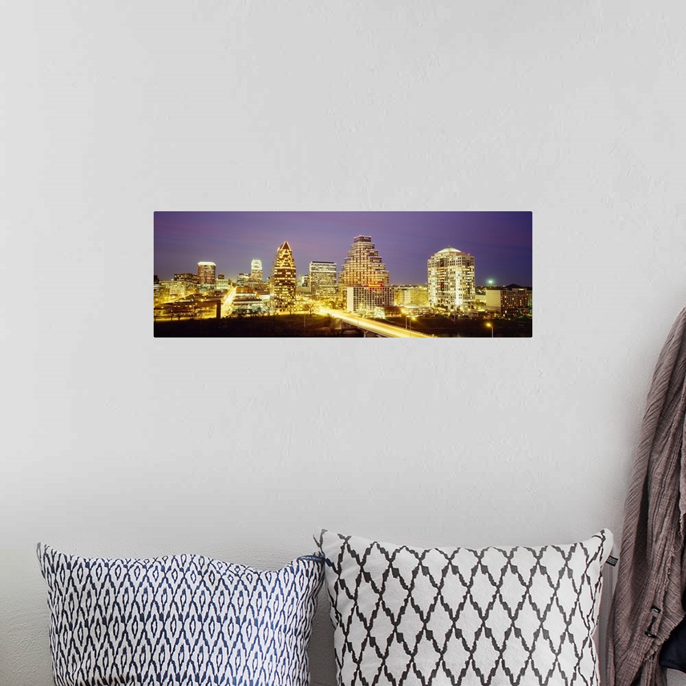 A bohemian room featuring Panoramic photo of a cityscape brightly lit up at night with slow exposed car lights going throug...