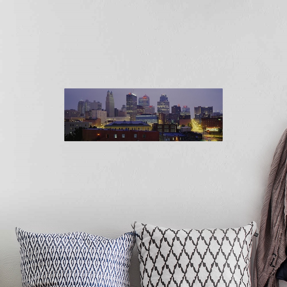 A bohemian room featuring A panoramic photograph of the downtown city skyline with several small residential or warehouse b...