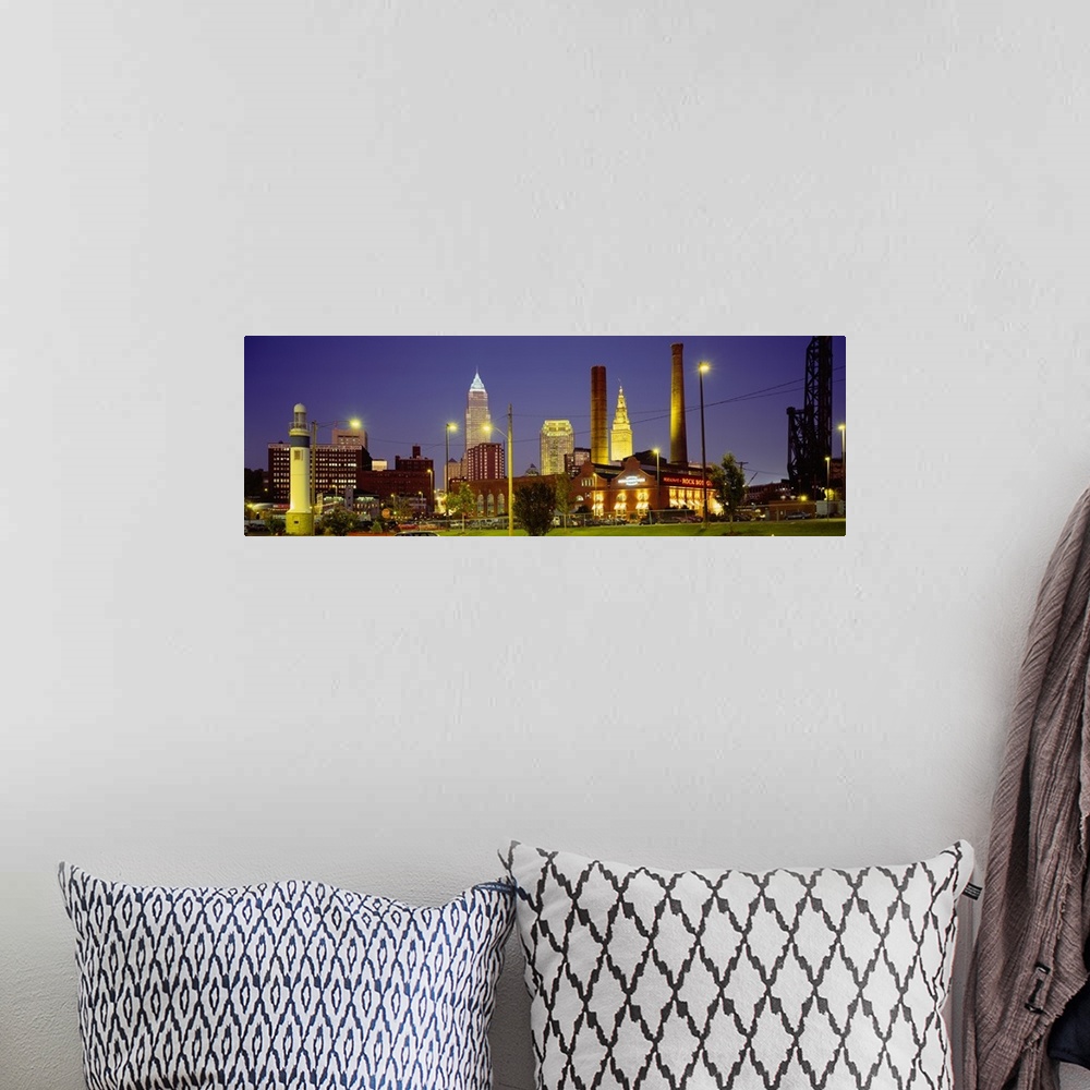 A bohemian room featuring Panoramic image of buildings lit up at night in a downtown Ohio city.