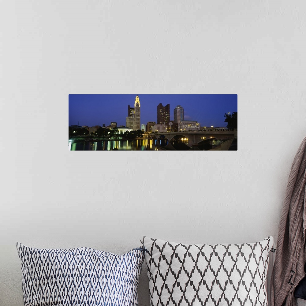 A bohemian room featuring The city of Columbus Ohio is illuminated under a night sky and photographed in panoramic view fro...