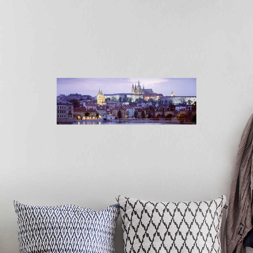 A bohemian room featuring Wide angle photograph of buildings in Prague, Czech Republic, lit up at night, including Hradcany...