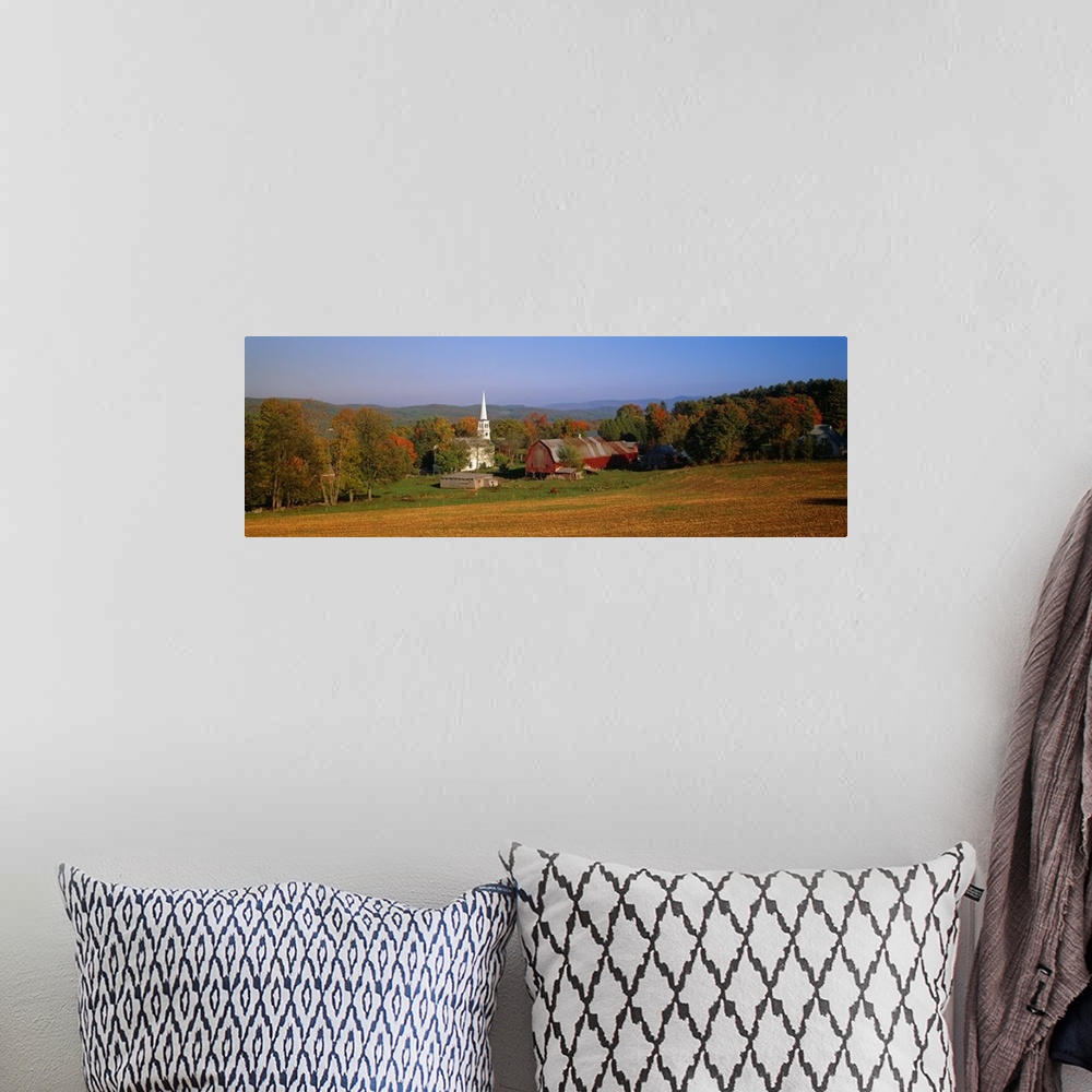 A bohemian room featuring This panoramic photograph is of a barn and a church surrounded by autumn trees with large hills i...