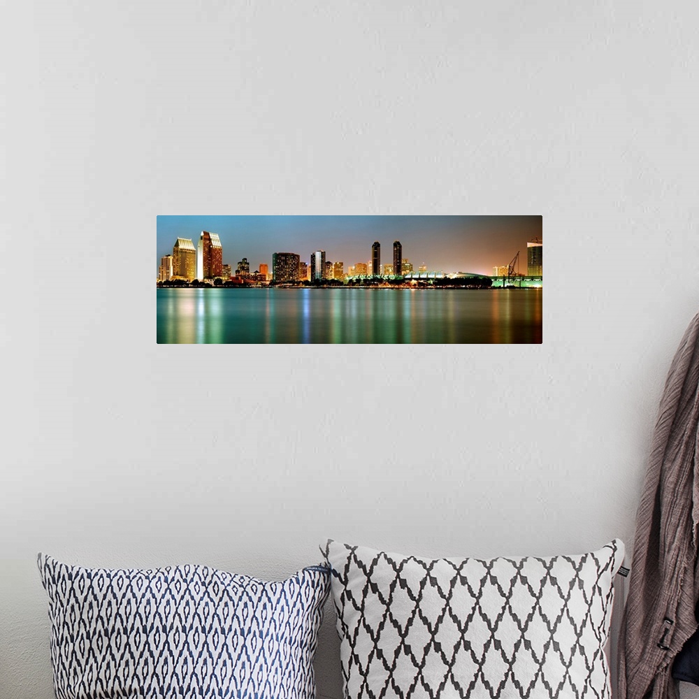 A bohemian room featuring City lights reflect in still waters of the cityscape panoramic wall art.