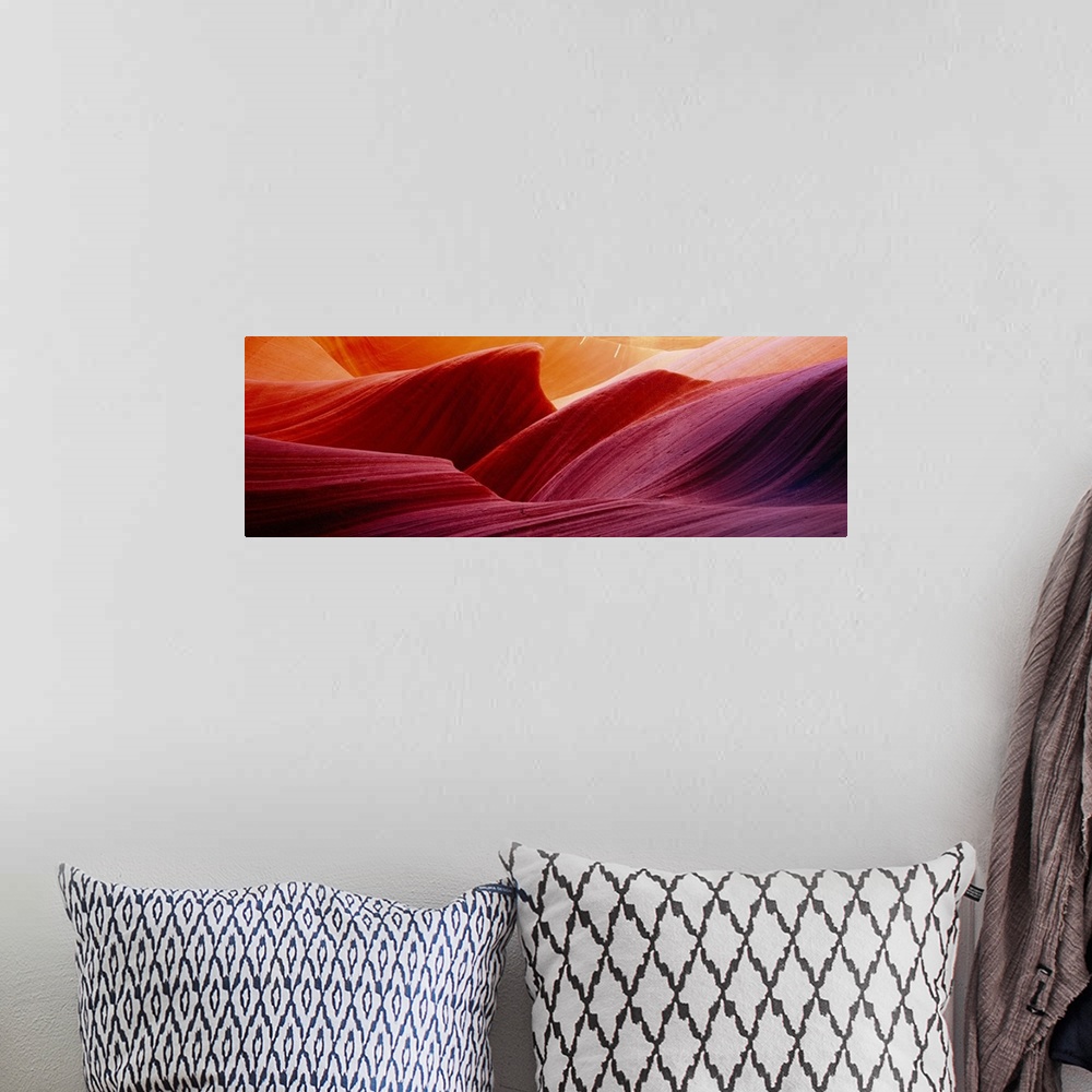 A bohemian room featuring Panoramic photograph of eroded rock in Antelope Canyon, with light forming wavy patters as it bou...