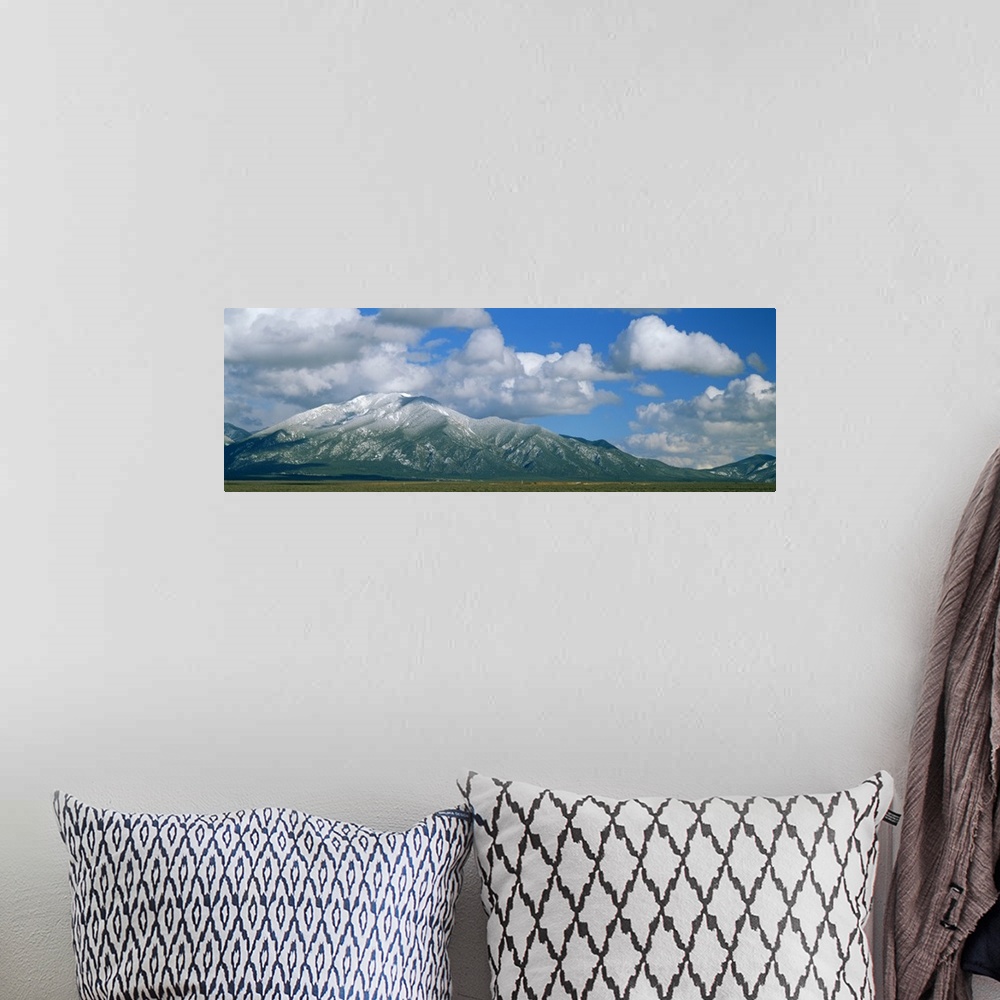 A bohemian room featuring Clouds over snowcapped mountains, Taos, New Mexico