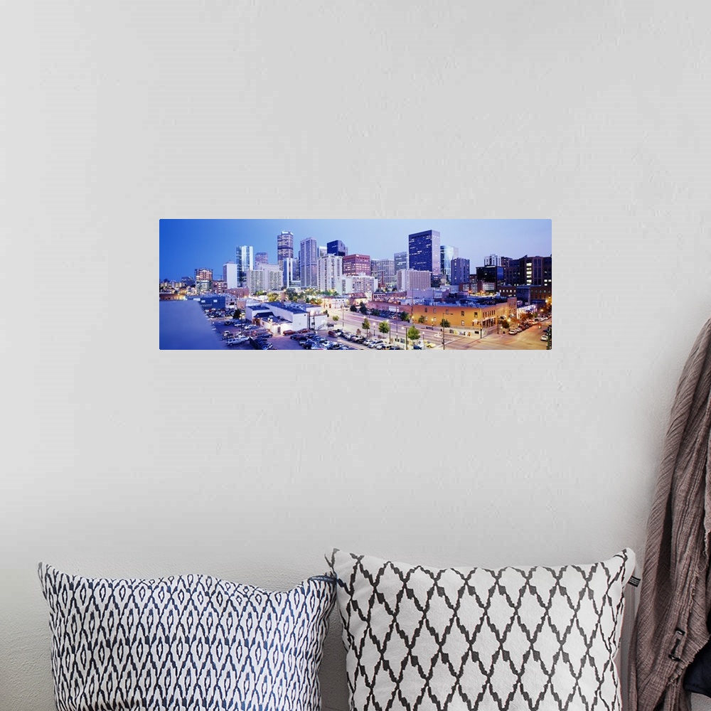 A bohemian room featuring Panoramic view of a vibrant downtown Denver on canvas.