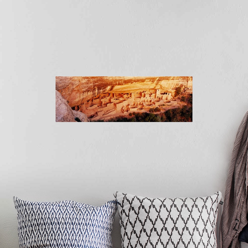 A bohemian room featuring This panoramic vista looks down into the cliff dwellings of the ancient Pueblo people as the ston...