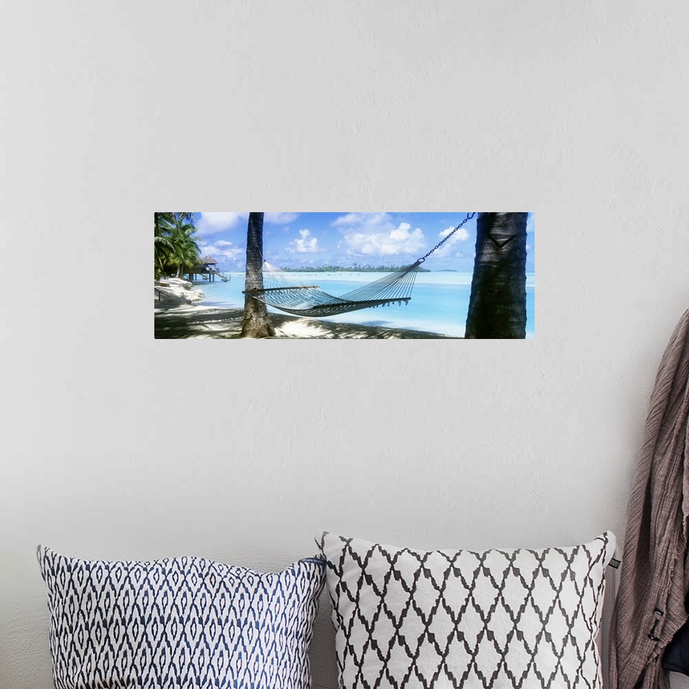 A bohemian room featuring Panoramic photograph of a hammock hanging between two palm along the shore of the Cook Islands, c...