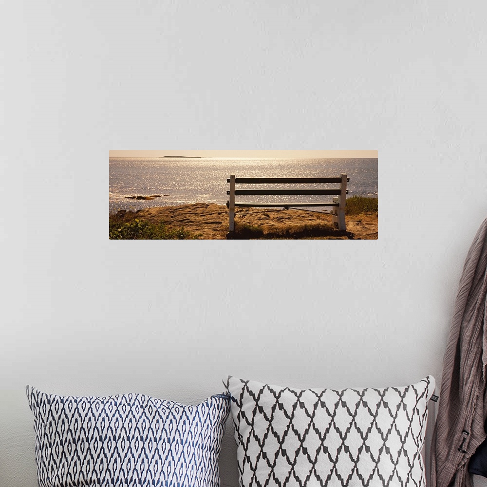 A bohemian room featuring Panoramic photo on canvas of an empty bench overlooking a beach in the northeast US.