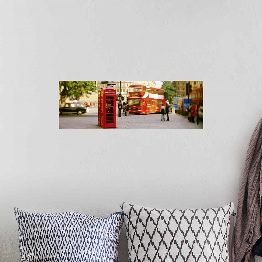 A bohemian room featuring Big horizontal photograph of a red telephone box in Trafalgar Square, London, surrounded by pedes...