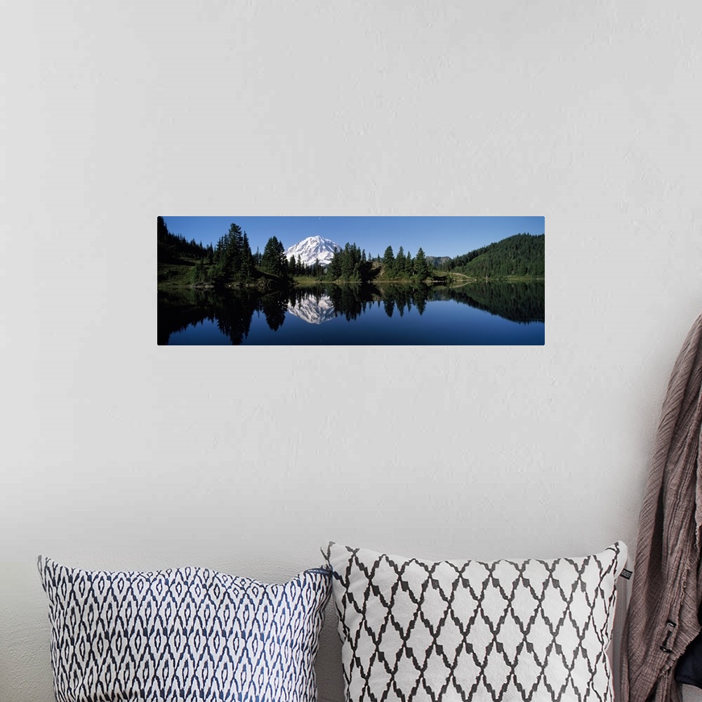 A bohemian room featuring Panoramic photograph of Mount Rainier and surrounding green forest, reflecting in the still water...