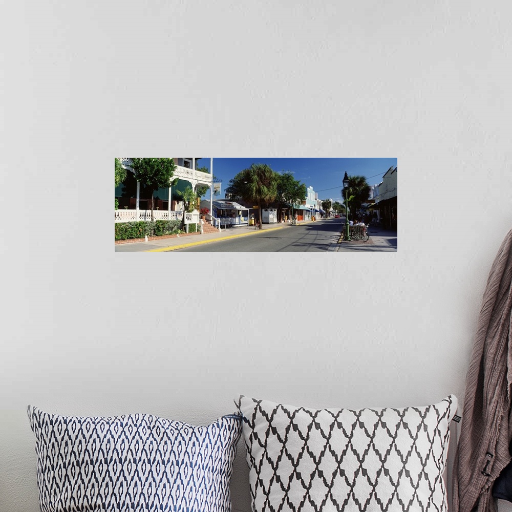 A bohemian room featuring Panoramic photograph of street lined with shops in southern beach town.