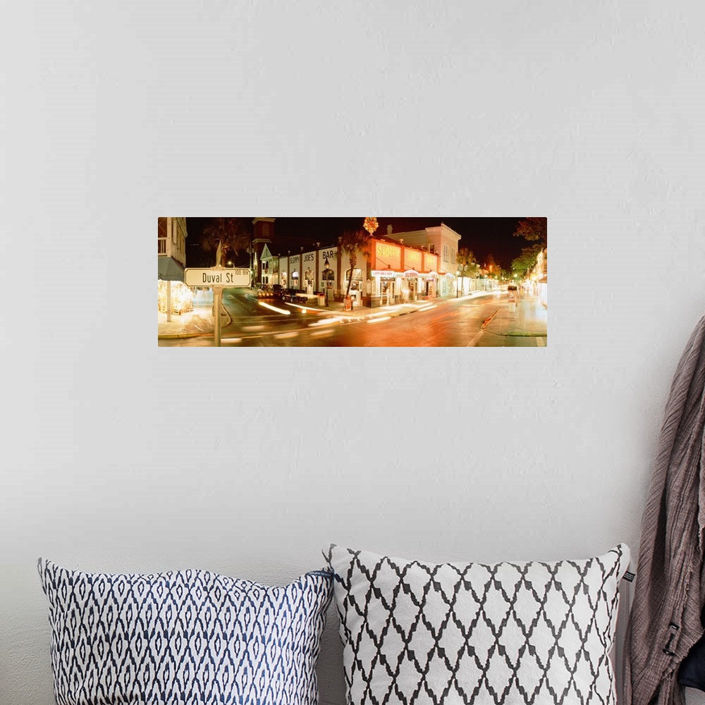 A bohemian room featuring Panoramic photograph of street level view of busy intersection.  The buildings are lit up and the...