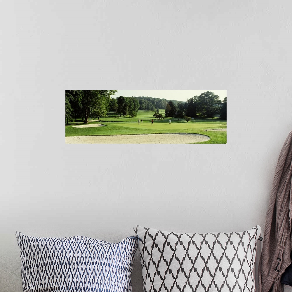 A bohemian room featuring Four people playing on a golf course, Baltimore County, Maryland