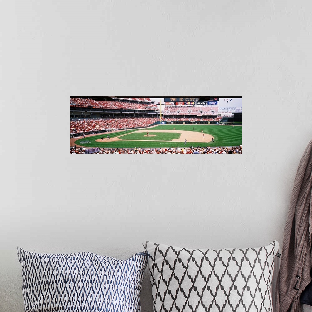 A bohemian room featuring Long horizontal image of a baseball game being played as spectators watch in Ohio.
