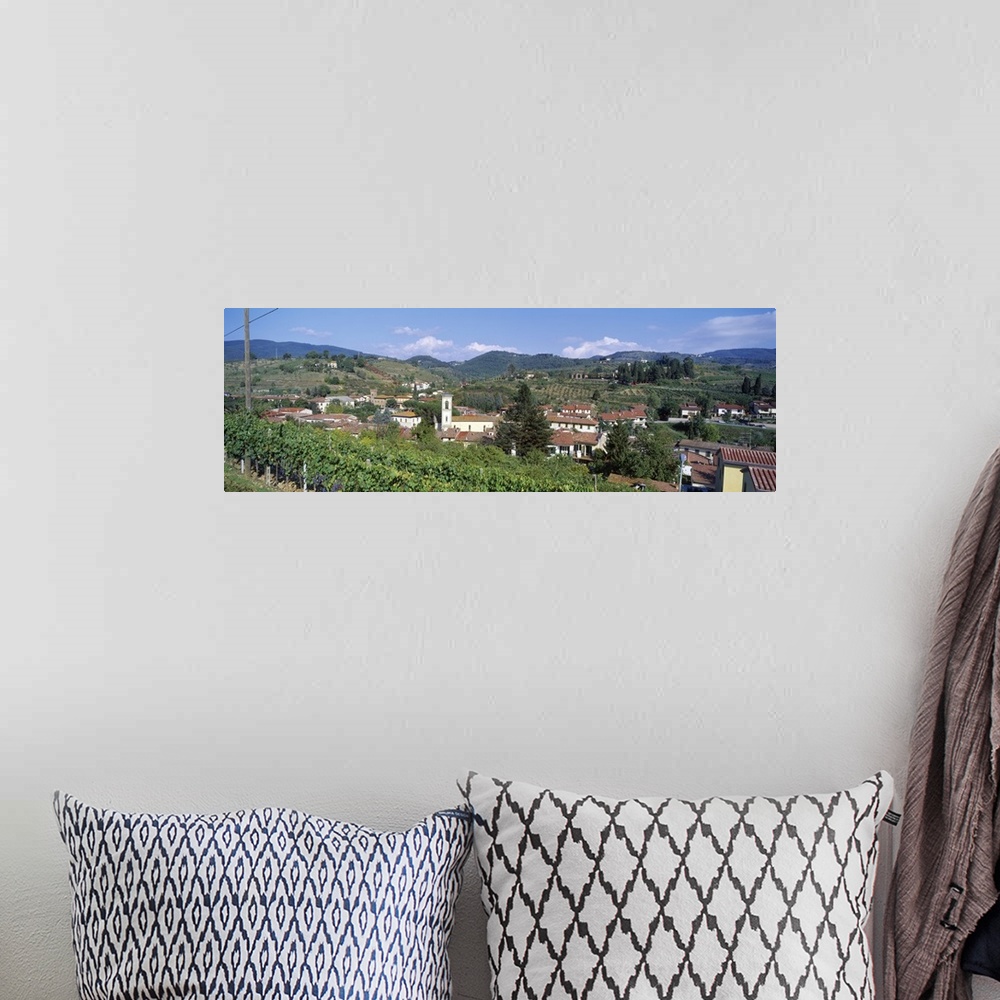 A bohemian room featuring Panoramic canvas photo of an Italian town on rolling hills.