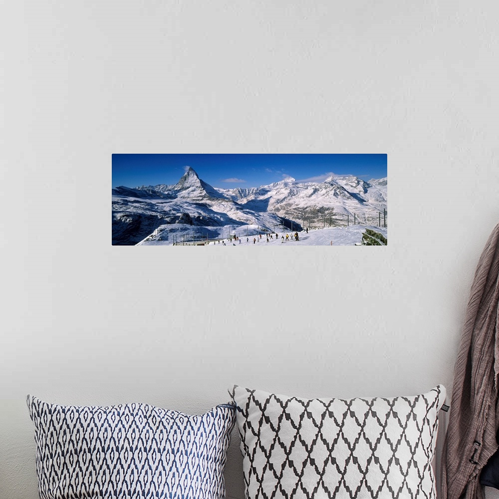A bohemian room featuring Group of people skiing near a snow covered mountain, Matterhorn, Switzerland