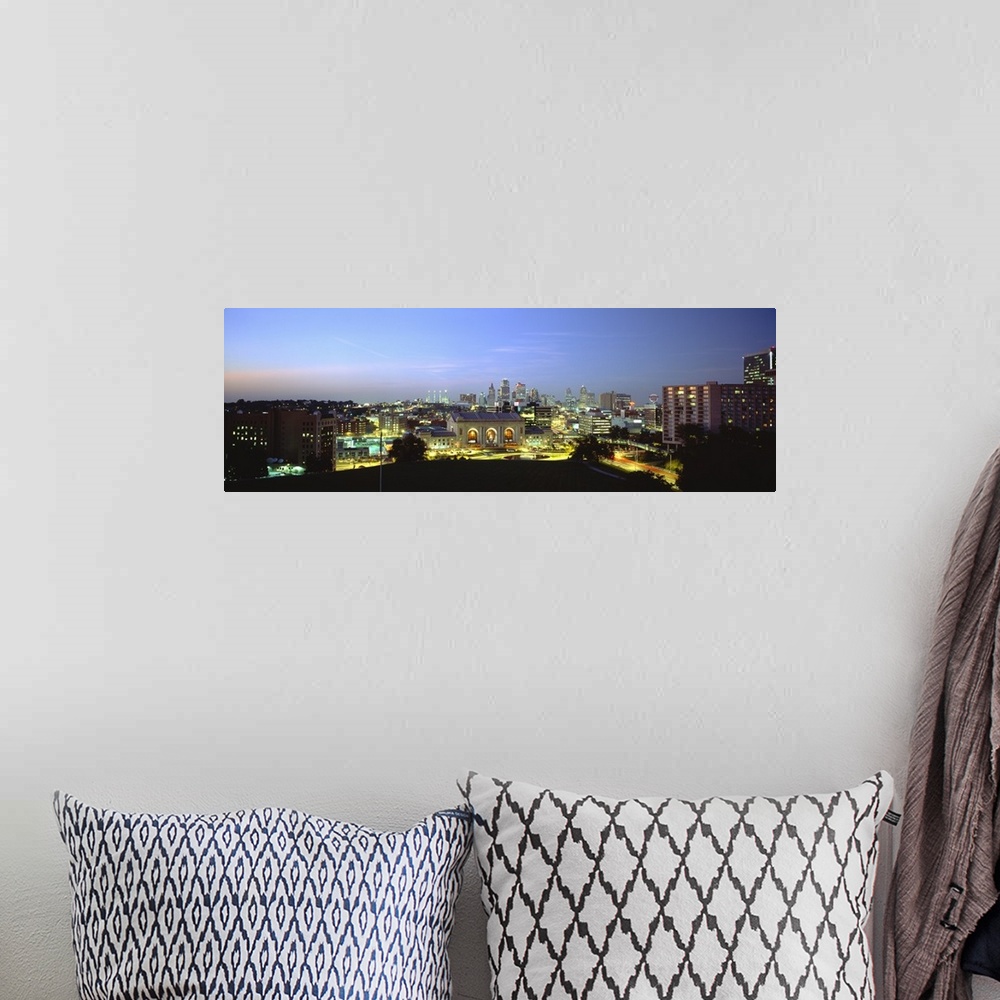 A bohemian room featuring Large panoramic image of a downtown cityscape in Missouri lit up at night.