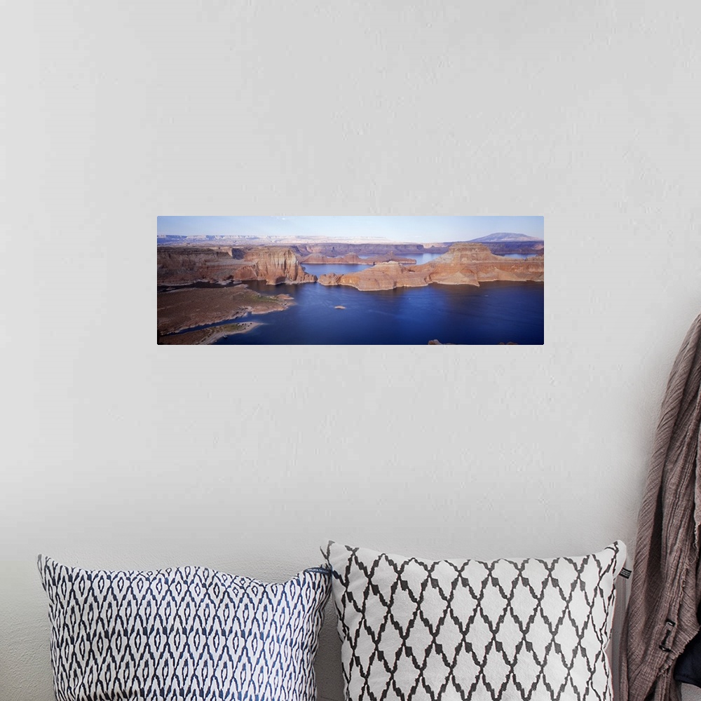 A bohemian room featuring Panoramic photograph of river running through gorge under a clear sky.