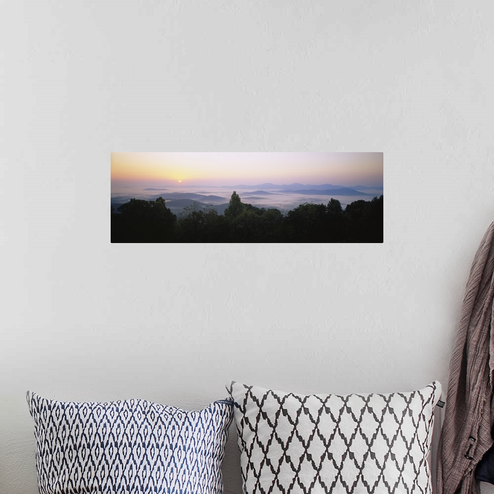 A bohemian room featuring Large panoramic photograph of mountains in Virginia with the sun setting far in the distance and ...