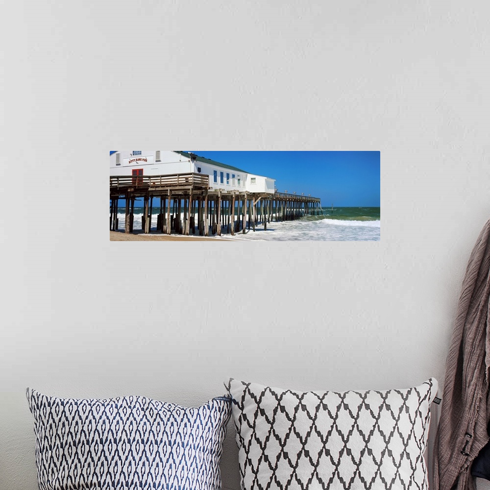 A bohemian room featuring Kitty Hawk Pier on the beach, Kitty Hawk, Dare County, Outer Banks, North Carolina, USA.